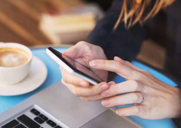 Woman on mobile phone bidding at auction Bond Wolfe Auctions - Property Auctions UK