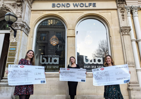 Three People holding donated Cheques